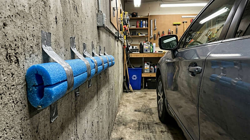 pool noodle mounted on garage wall